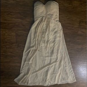 This is a cream color, strapless prom dress. It is a size Small.